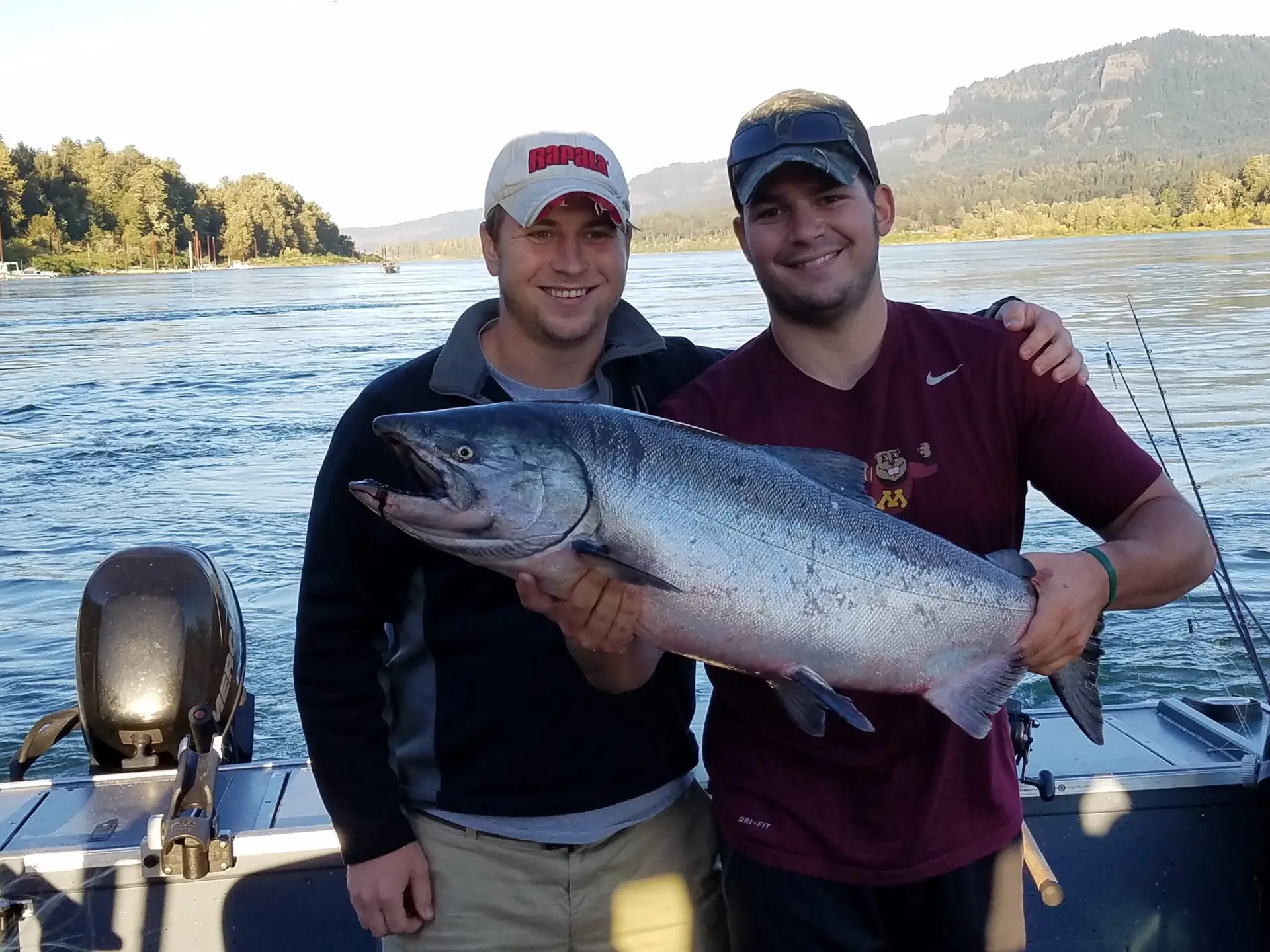 2 guys holding salmon