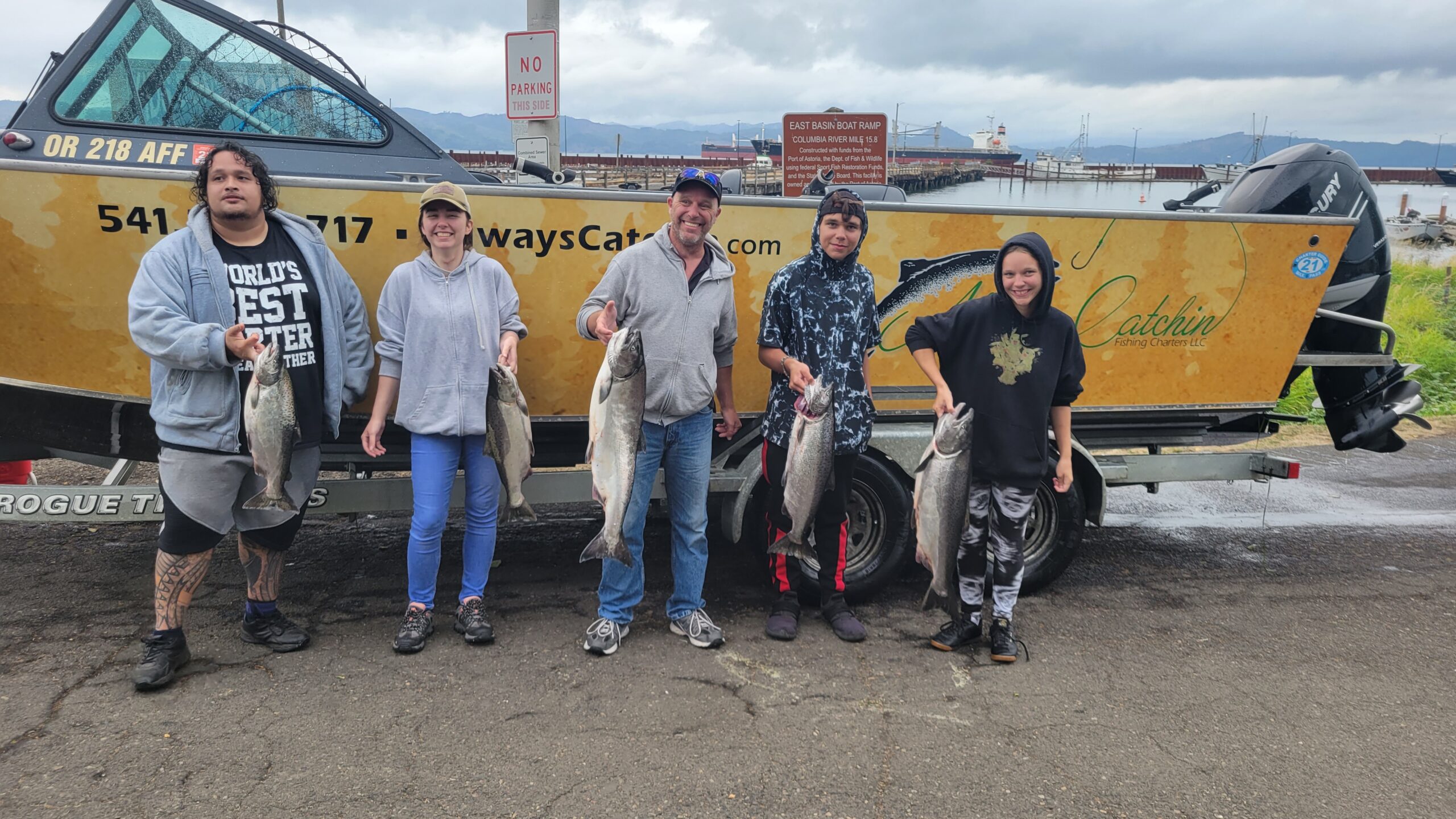 5 people holding 5 salmon in Astoria