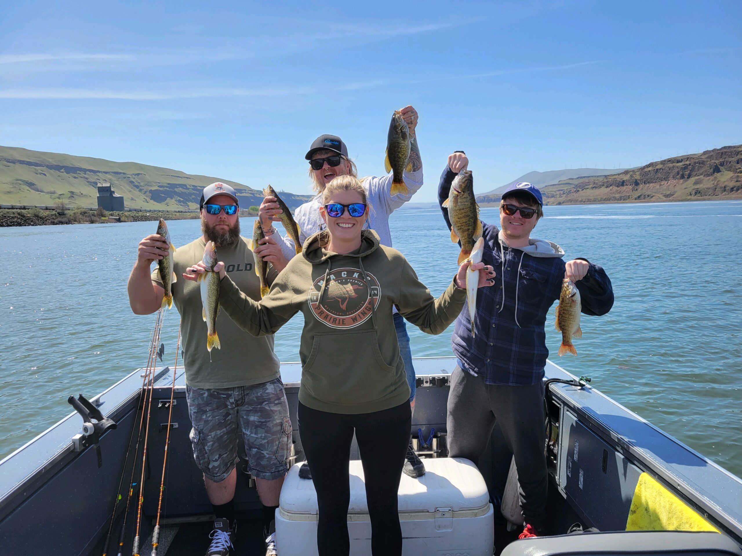 4 people holding up their walleye they caught